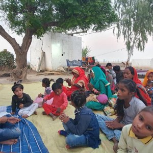 a group of people sitting on a blanket