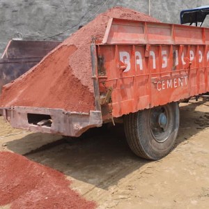 a truck driving down a dirt road