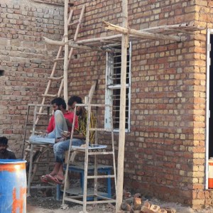 a man standing in front of a brick building