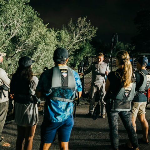 a group of people standing in a parking lot