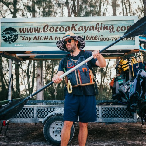 a man standing in front of a fence