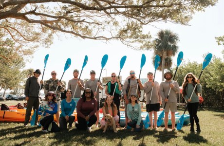 a group of people standing in front of a crowd posing for the camera