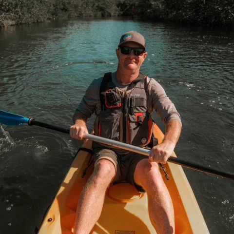 a man rowing a boat in the water