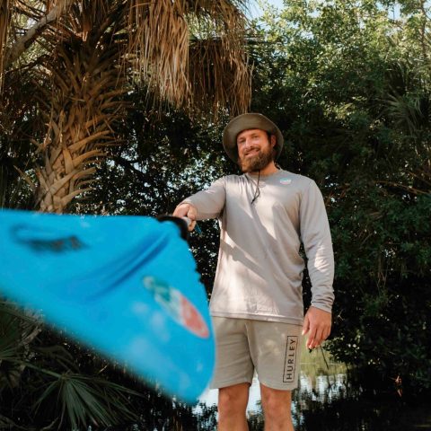a man standing next to a tree