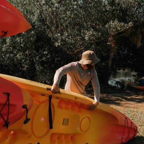a man holding an orange umbrella