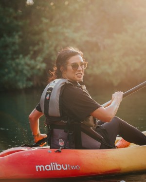 a person standing next to a body of water