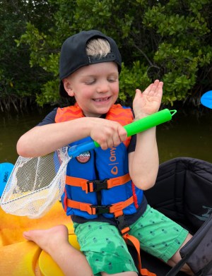 a little boy that is holding a frisbee