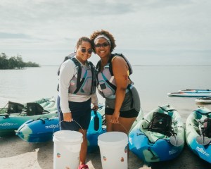 a man and a woman standing in front of a boat