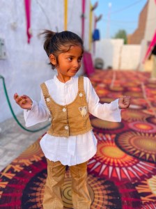 a little girl holding a colorful umbrella