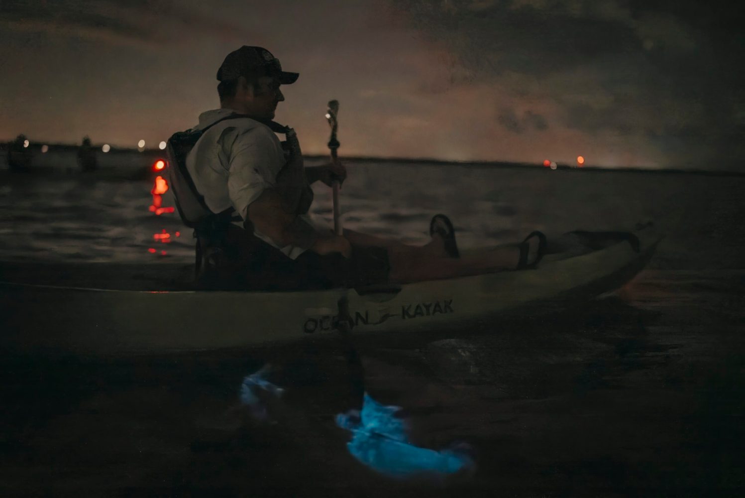 a man standing next to a body of water