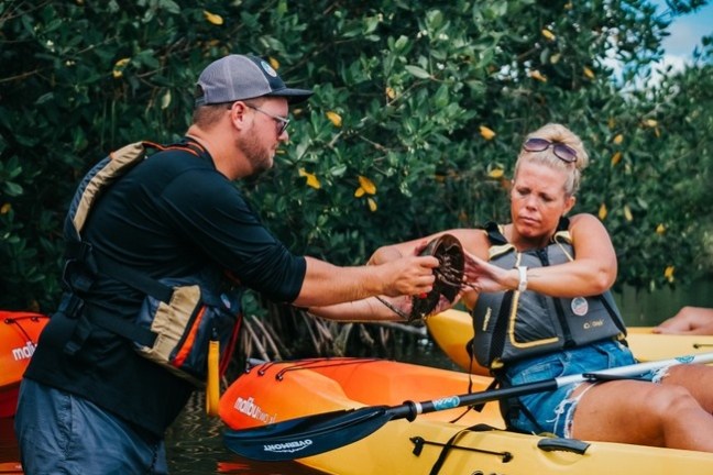 a group of people riding on the back of a boat