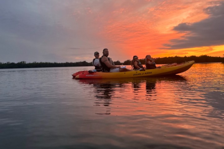 a group of people in a boat on a body of water