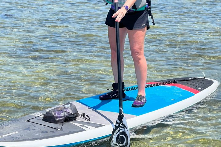 a person riding on the back of a boat in a body of water