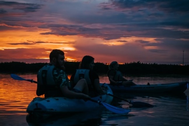 a man and a sunset over a body of water