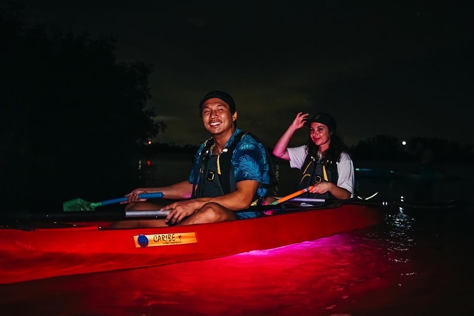 a man sitting in a boat on a body of water