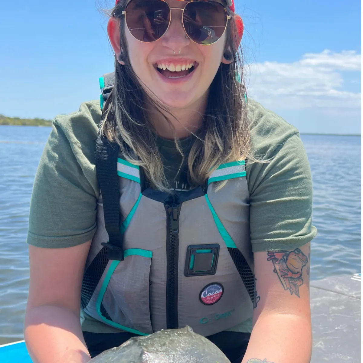 a woman standing next to a body of water